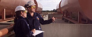 An image of two people on a mine site with hardhats